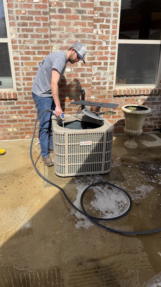 Delta Cooling technician performing HVAC maintenance in North Louisiana