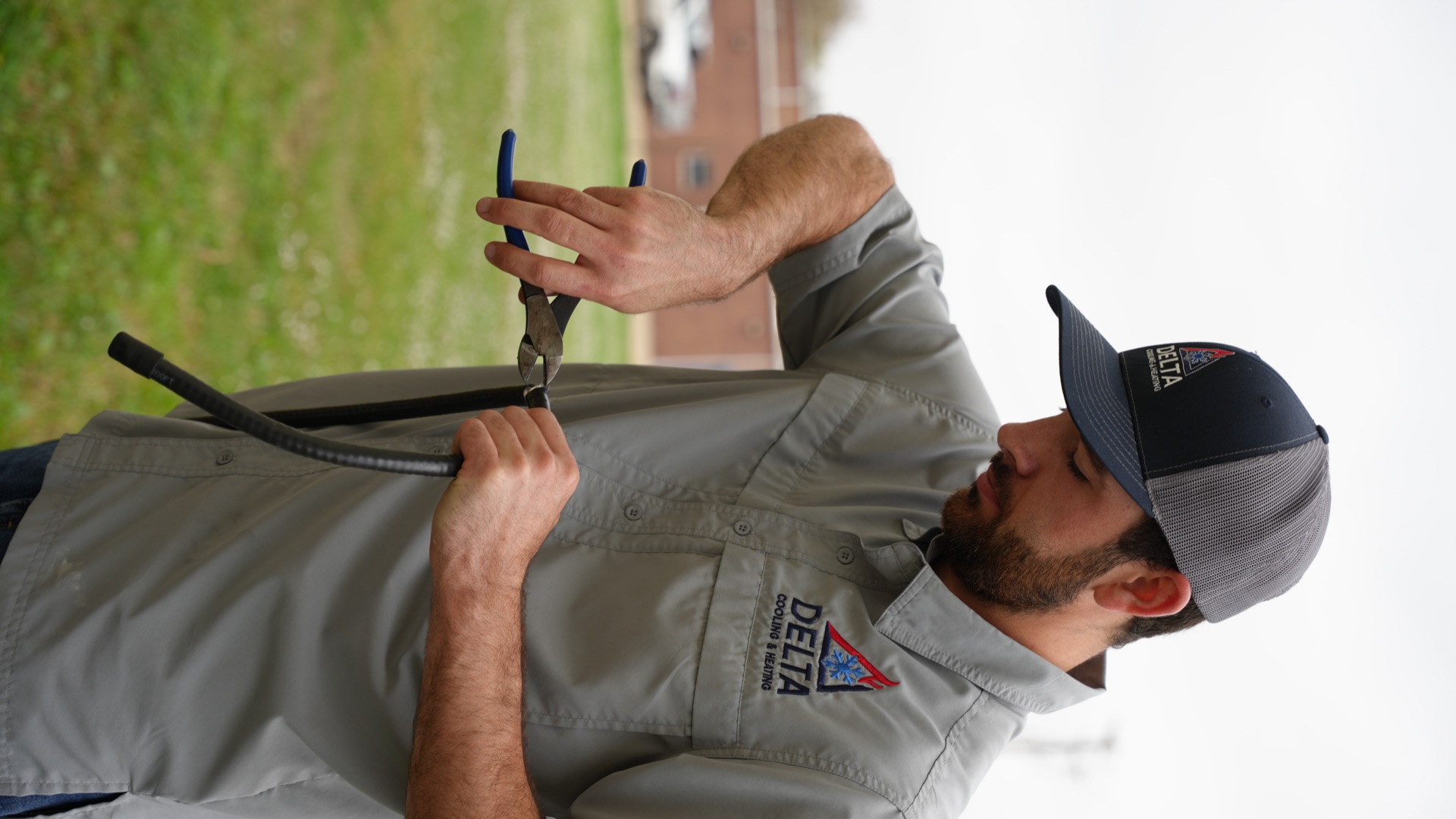 Delta Cooling & Heating HVAC technician servicing air conditioning unit in Calhoun Louisiana